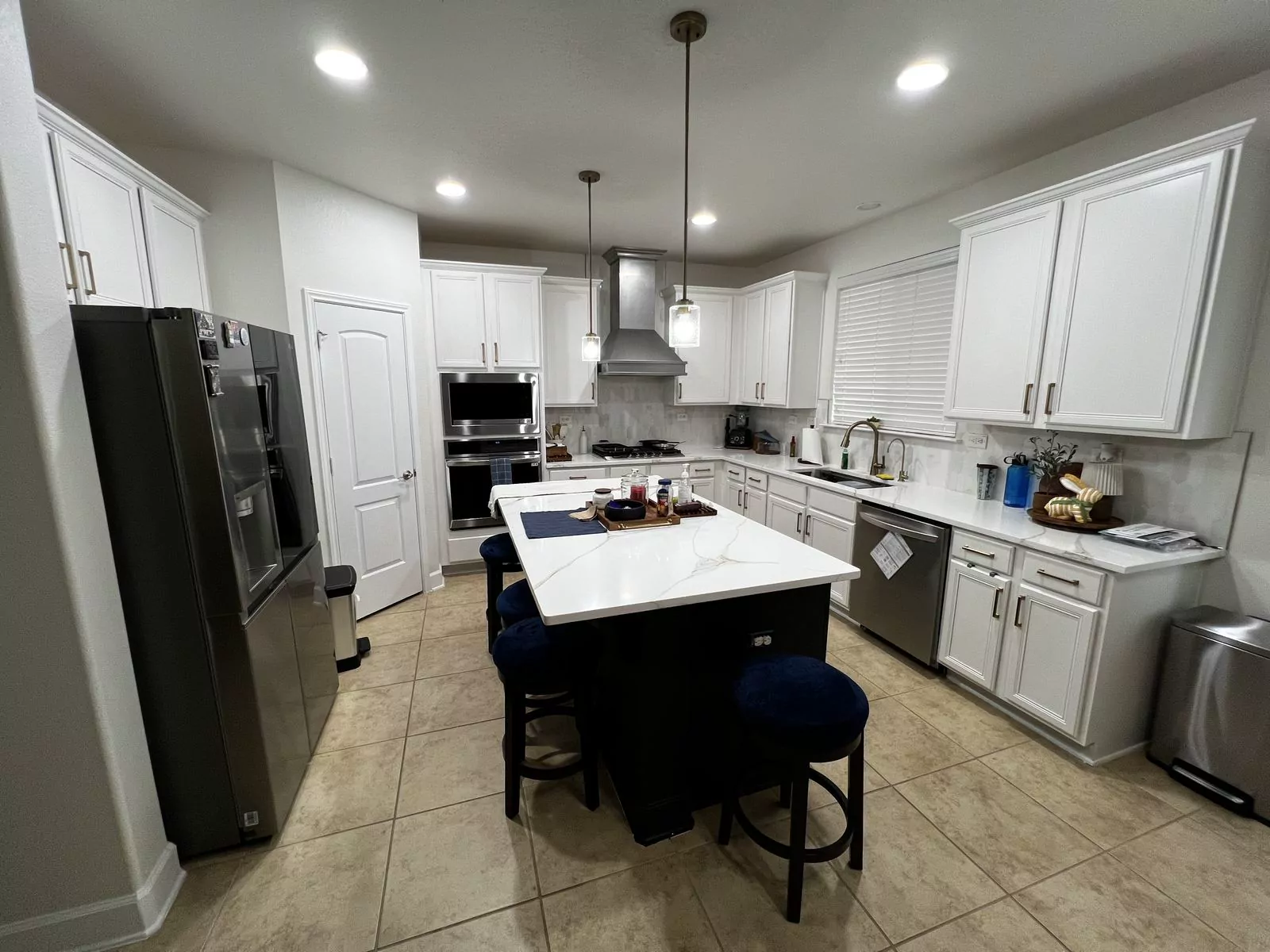 White kitchen, black island by Flip Fixer